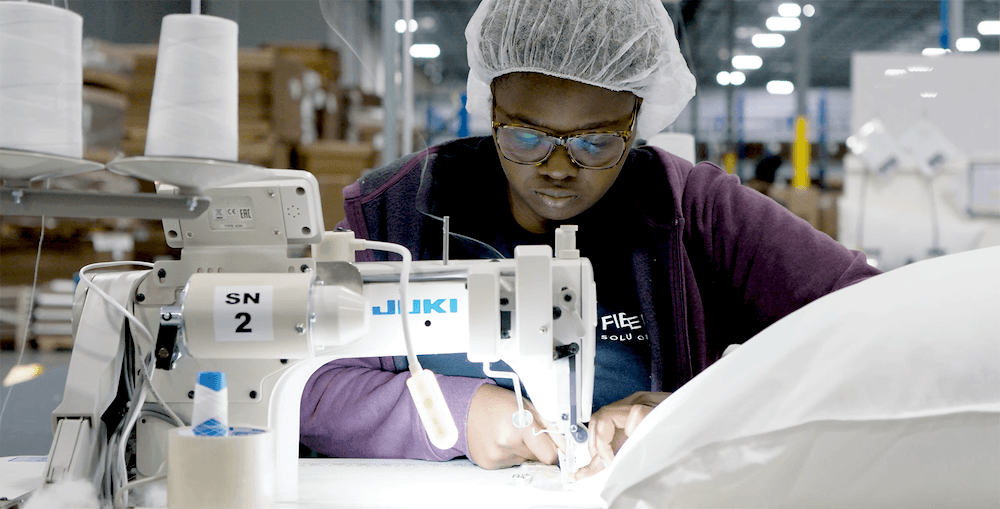 A member of the Atlanta team fills pillows and dog beds shipped to East Coast customers.