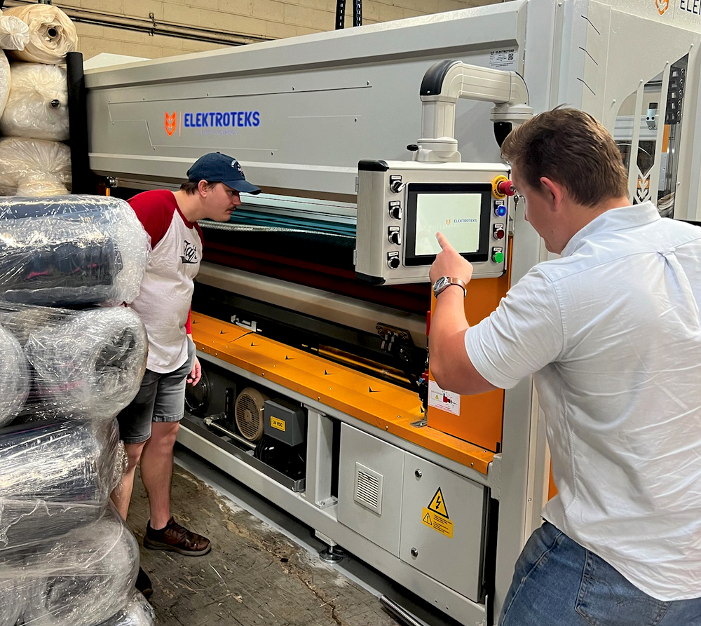 Michael and Ryan Rowden check out a new roll-packing machine at Made Rite’s facility in Franklin Park, Illinois.